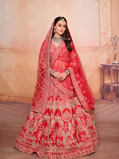A full-length view of the bride, capturing the grandeur of the red lehenga and the elegance of the makeup and hair.
