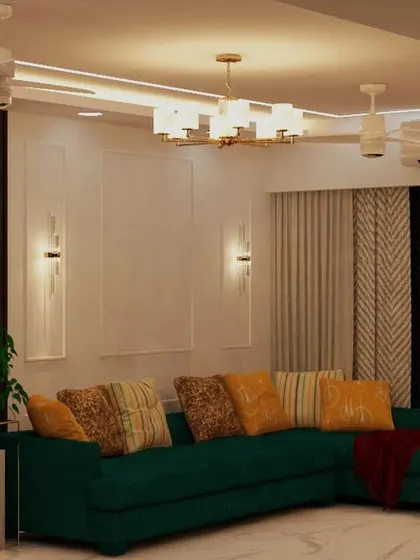 Another view of the living room with the green sectional sofa, highlighting the elegant wall molding and sconces.