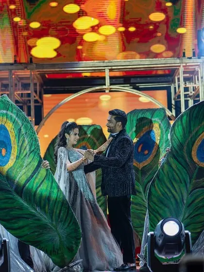 A stunning couple dance featuring large, ornate peacock feather props. We use creative props to build a thematic and visually rich performance.