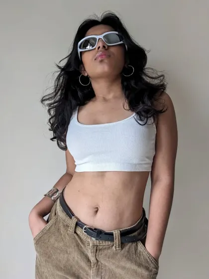 Another angle from the "Phoenix" photoshoot, showing off the windswept hair and cool sunglasses.
