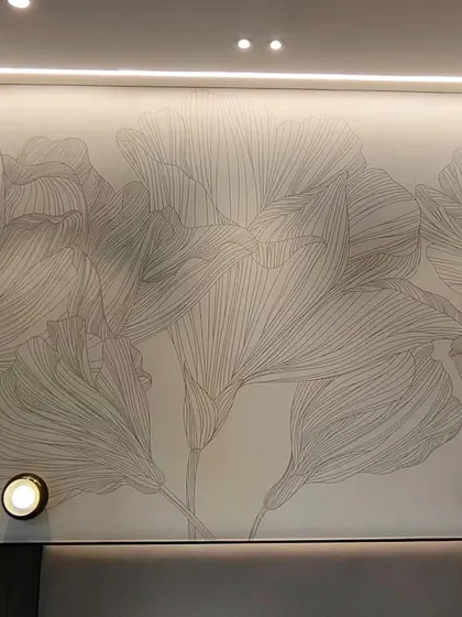 A delicate line-art floral mural installed above a headboard in Vile Parle. The minimalist design is enhanced by the wall-mounted lights.