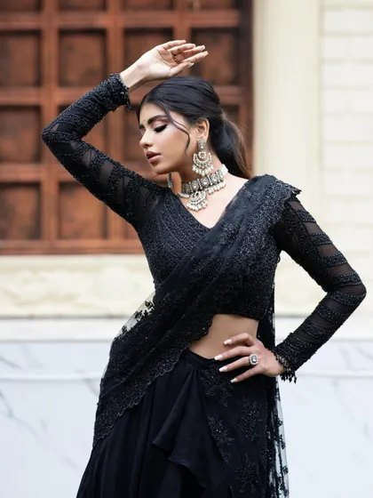 A closer look at the black Indo-Western outfit, showing the intricate hand embroidery and the modern silhouette.