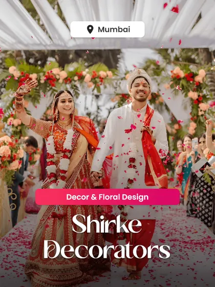 A promotional image showcasing our decor and floral design for a beautiful wedding ceremony. The happy couple is framed by the floral archway and petal-strewn aisle we created for their special day.