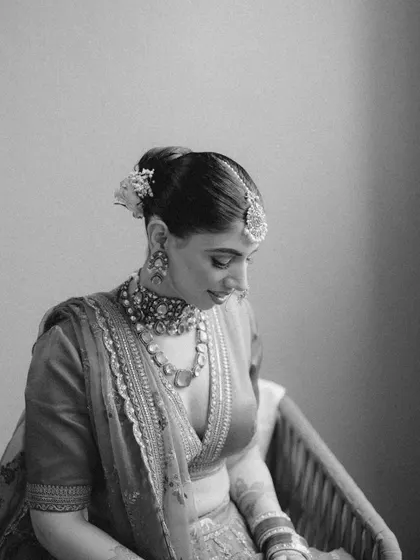 A quiet, pensive black and white portrait of Akanksha. This image captures a moment of calm and reflection before the ceremony.