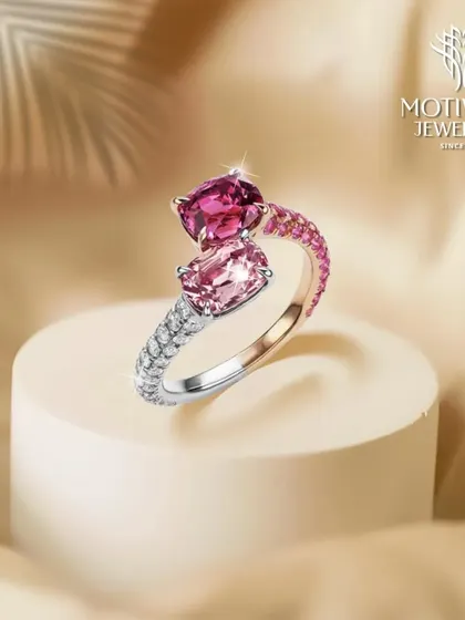 A contemporary "toi et moi" ring featuring two vibrant pink gemstones in different hues, set on a diamond-paved band. This design symbolizes the union of two souls.