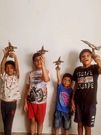 A squadron of young builders shows off the fighter jet models they completed during our workshop.