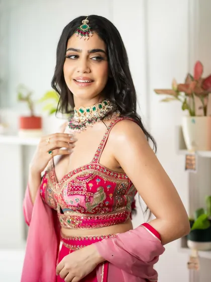 A detailed close-up of the blouse's intricate embroidery and the stunning jewelry. This is great for brands wanting to showcase craftsmanship.