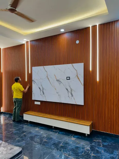 A wide shot of the full-wall TV unit, showing how it dominates the space and becomes the centerpiece of the living room.