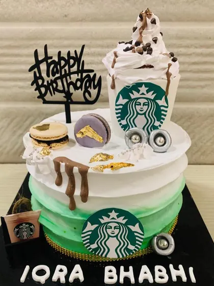 For the Starbucks lover! This cake is designed to look like a Frappuccino, complete with the green logo, whipped cream topping, and a macaron on the side.