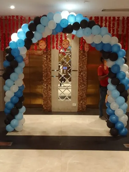 A fun Boss Baby-themed entrance arch for a birthday party, using a classic blue, black, and white color scheme.