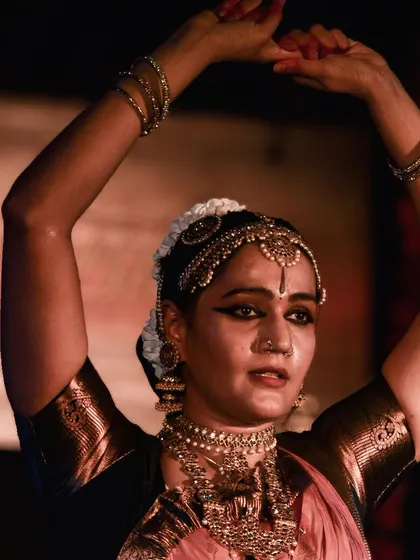 The focus and determination in the dancer's eyes during a complex piece.