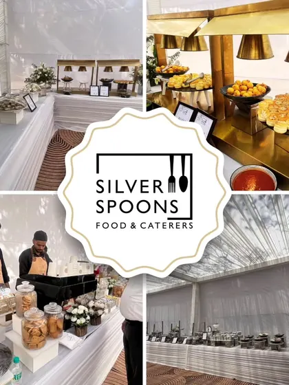 A complete view of our catering setup for a large event, featuring a clean white theme with elegant floral decor, multiple buffet lines, and a live counter.