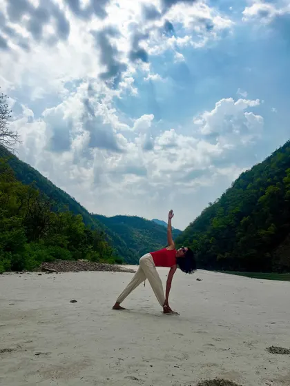 Grounding myself with Trikonasana on the banks of the Ganga. The energy of this sacred river and the surrounding mountains makes every breath and movement feel more meaningful.