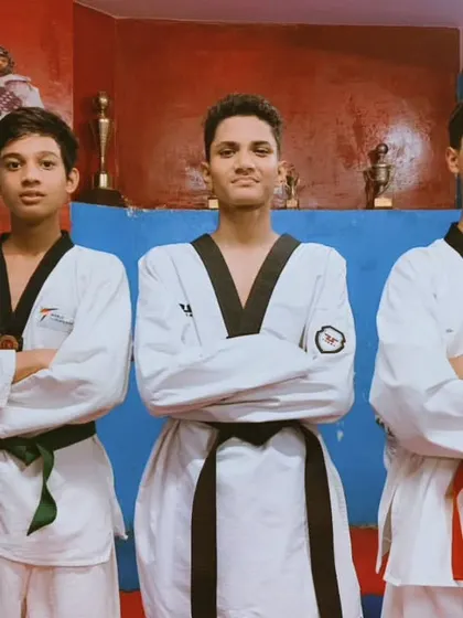 Three of my senior students, standing with the confidence and discipline that comes from years of training. They are role models for the younger ones.