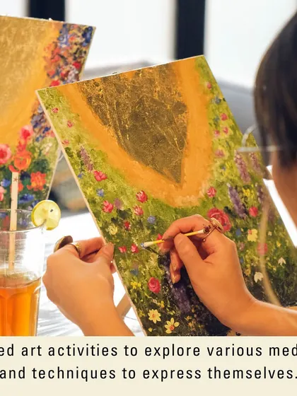 A close-up of a participant working on a beautiful gold leaf painting. This guided activity allows everyone to explore a sophisticated medium and express themselves.