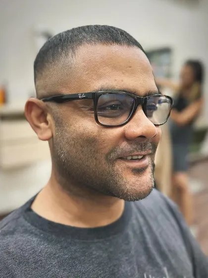 The same skin fade crew cut, but this time you can see the client's happy reaction. A good haircut should not only look good but also make you feel great.