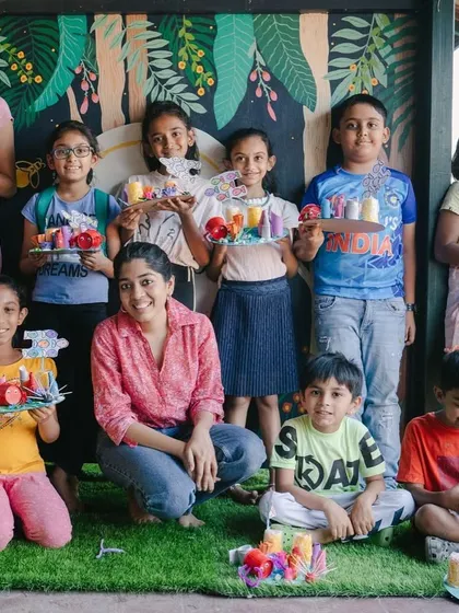 This is what a successful art camp looks like! A group of happy kids, a proud instructor, and a table full of amazing, colorful sculptures they all made themselves.