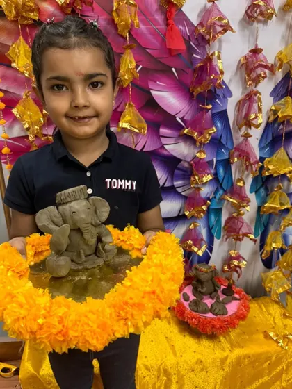 This young artist is all smiles with his handmade Ganesha and Mushak, ready for the celebration.