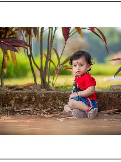 A slightly different angle from the same outdoor session, capturing a direct and engaging look from the child.