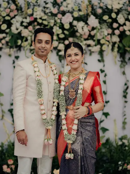 The happy couple, Sonika and Abhishek, during their engagement. The lush floral wall behind them, composed of thousands of real flowers, provided a beautiful and fragrant setting for their celebration.