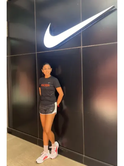 Standing by the iconic Nike swoosh. Being a pacer allows me to share my passion and help other runners achieve their goals.
