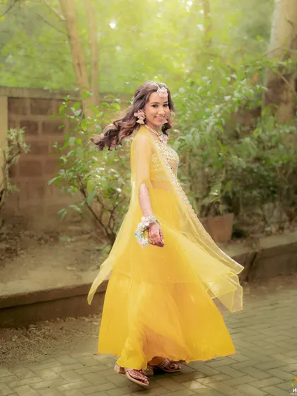 A happy, twirling bride at her Haldi. The movement shows how light and comfortable our floral jewellery is, allowing for uninhibited celebration.