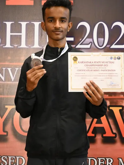 A silver medal earned through hard work and dedication at the state-level Muay Thai tournament.