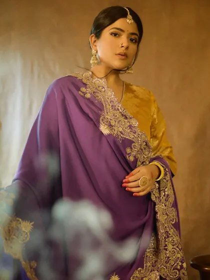 A beautiful, soft-focus shot of Sakshi Gopal. The makeup enhances her features while maintaining the vintage, film-like quality of the photoshoot.