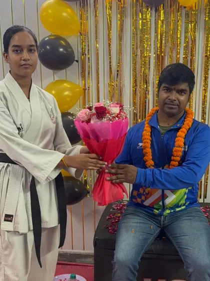 A female black belt student, a role model for others, showing her respect and appreciation for her teachers.