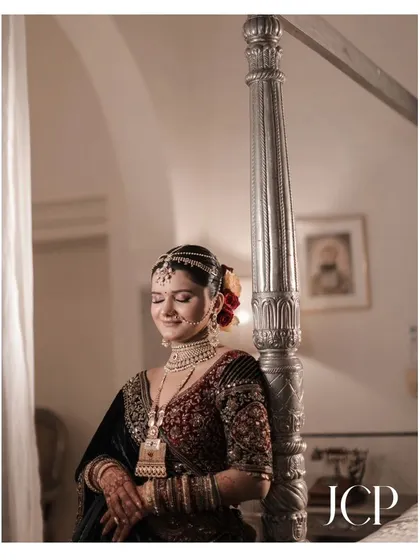 A happy bride enjoying a quiet moment before her ceremony at Hotel Chomu Palace.