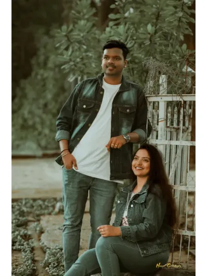 A relaxed portrait of a couple in denim, sitting and standing in a park. This shot captures their easy-going and stylish vibe.