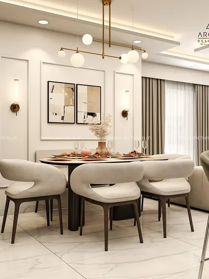 The dining area in this modern home features elegant wall mouldings and contemporary art. The design is sophisticated and perfect for hosting, with stylish chairs and a statement light fixture.