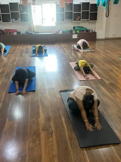 Awaken your inner warrior in our empowering group classes. These shots from our studio show students moving together, creating a powerful collective energy.