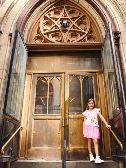 We used the grand architecture of this doorway to frame the shot. It adds a sense of scale and drama to this kids' fashion portrait.