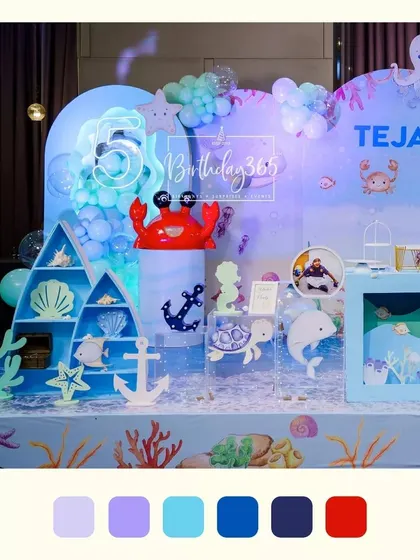 The main stage for Tejas's under-the-sea party, featuring a large crab prop, an anchor, and a variety of friendly sea creatures.
