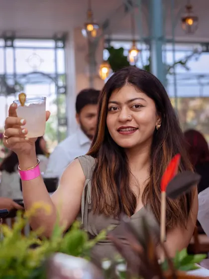 A guest raises her glass in a toast. The launch of Puffizza 2.0 was a night of nostalgia and new discoveries, with guests tasting the buttery, flaky delight of youthful past.