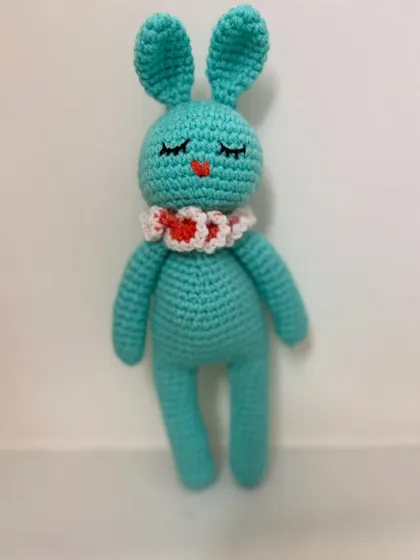 A sleepy turquoise bunny with a cute heart collar. This amigurumi toy is about 10 inches tall and is made with soft, durable yarn.