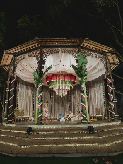 A night view of a Muhurtham ceremony, with a stunning floral chandelier as the centerpiece.