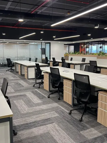 Another view of the Cube Highways office, showing the spacious layout and ample natural light. Low planters are used as dividers, adding greenery without obstructing views.