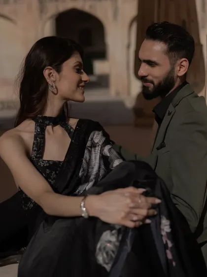 The look of love, captured in a candid moment during a royal pre-wedding shoot. The soft light and historic setting add a layer of timeless romance to this beautiful portrait.