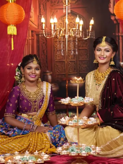 A beautiful Diwali-themed shoot featuring two different half sarees. On the left, a purple and yellow combination, and on the right, a classic cream and gold.