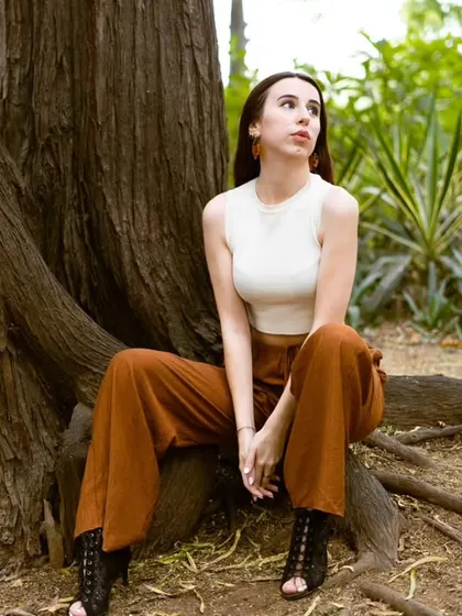 A portrait using the natural frame of a large tree. Outdoor shoots like this allow for beautiful, diffused lighting and a connection with nature that feels authentic.