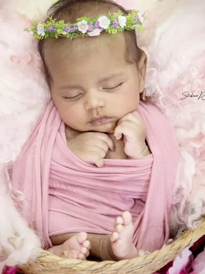 So serene and sweet, this little one looks like a tiny angel. The soft pink wrap and fluffy wool wings create a heavenly look for this newborn session.
