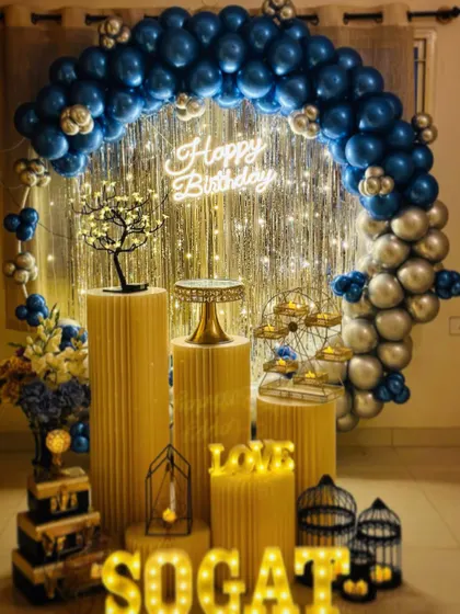 A classic blue and silver chrome balloon arch against a shimmer curtain. This elegant color combination is perfect for birthdays and other special occasions, and includes my full prop set with marquee letters.