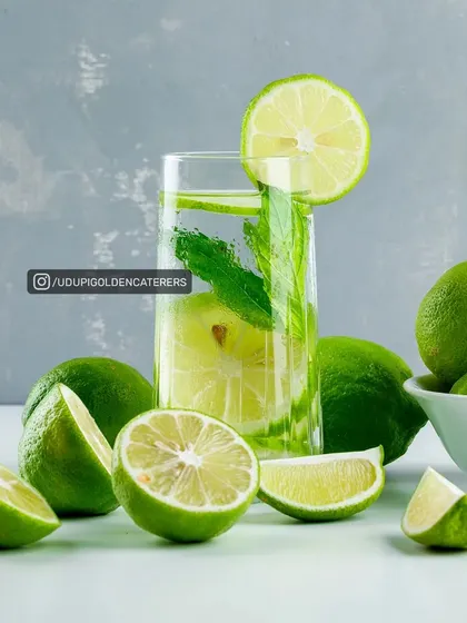 A classic Lime and Mint Cooler, a zesty and refreshing drink that is perfect for welcoming guests. It's a simple and elegant beverage choice.
