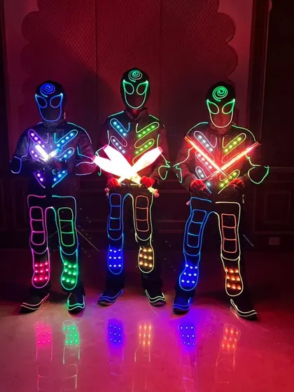 Our Tron performers are also skilled jugglers. Here, three of them pose with glowing LED juggling clubs, ready for the show.