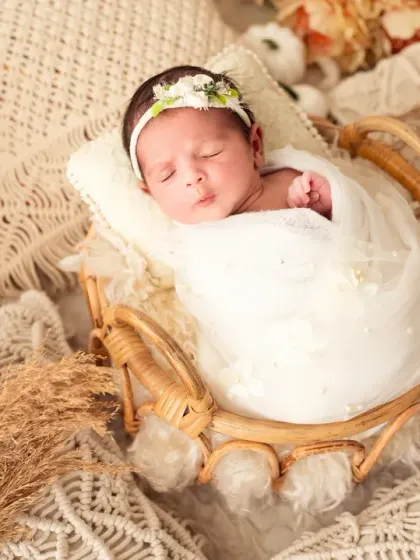 A peaceful moment as the baby girl in the boho setup falls asleep.