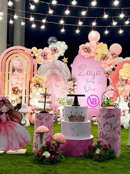 A stunning outdoor princess-themed first birthday party. This setup shows how we can create a grand and magical atmosphere in a garden setting with props, lighting, and detailed decor.