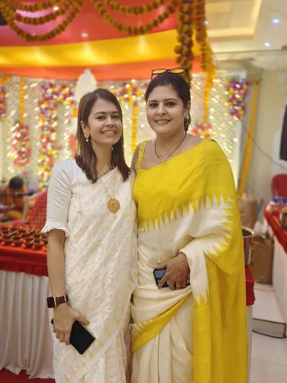 Posing with another guest at the Pooja. My styling philosophy is about standing out while still being appropriate for the occasion.