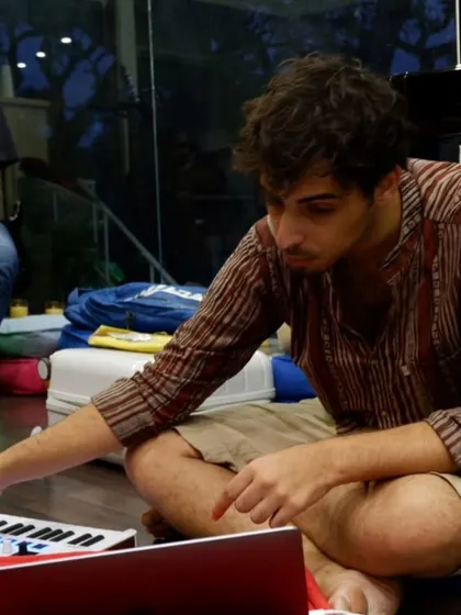 A student experimenting with an Arturia MIDI controller during a live performance workshop.